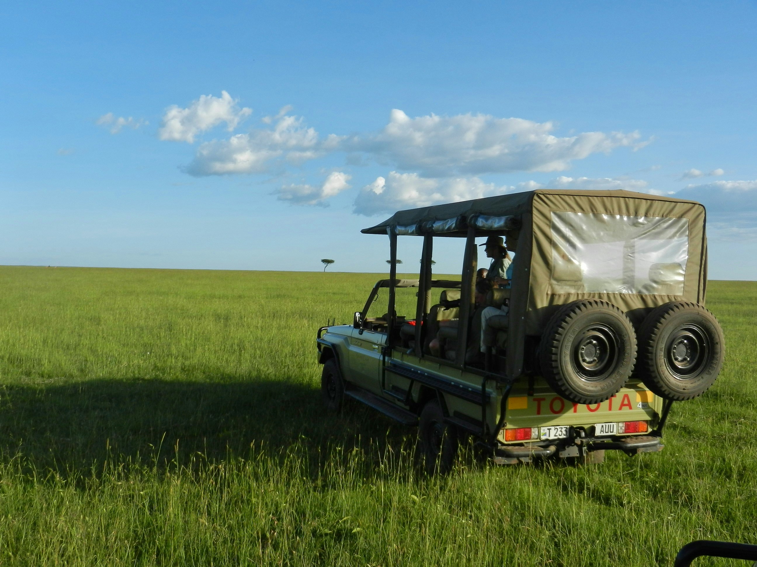 Safari vehicle on game drive in Kenyan National Park
